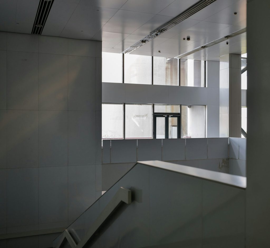 an empty building with a staircase and windows